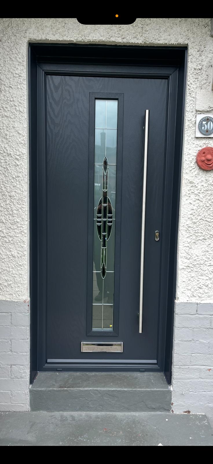 Anthracite composite door with art-nouveau leaded glass panel and a long stainless pull handle