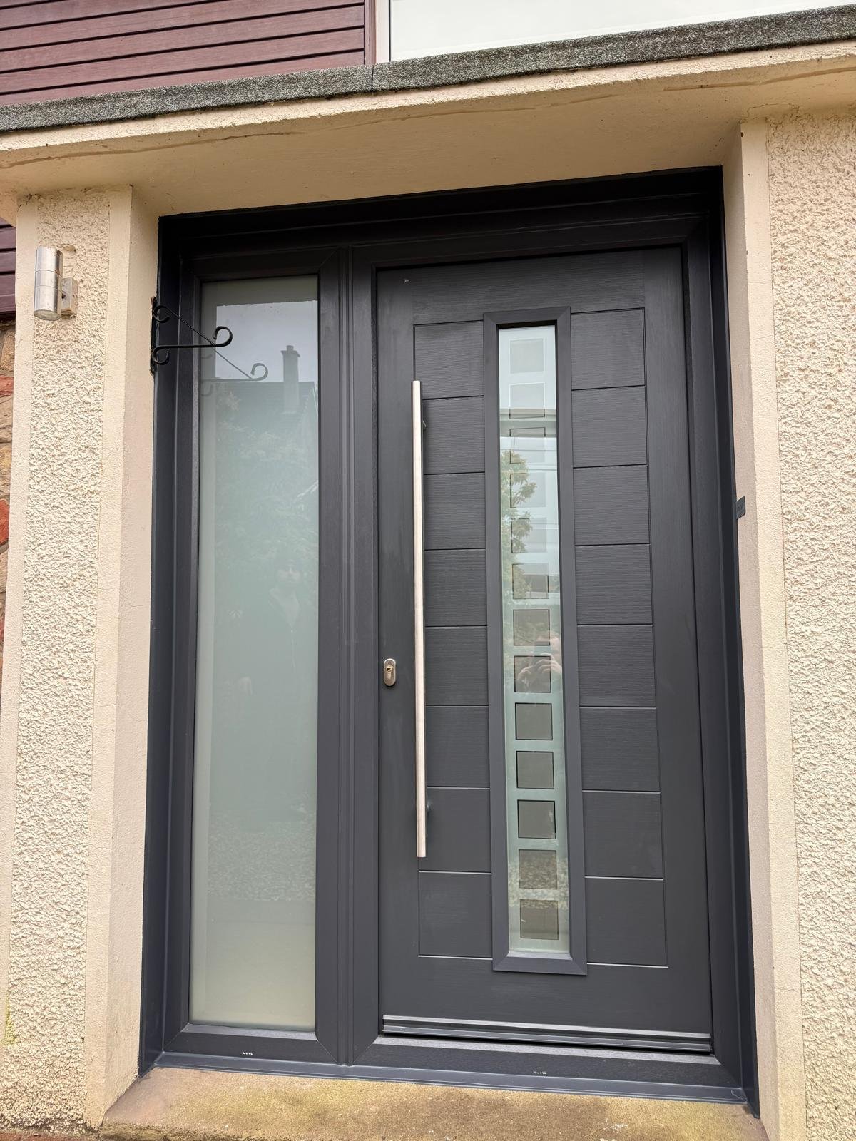 Black contemporary door with a single vertical glass strip