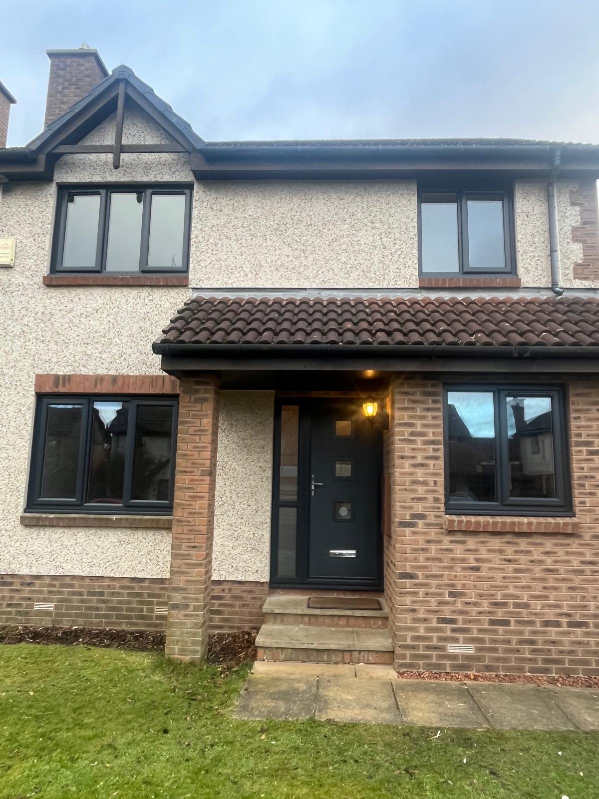 Two-storey house with all new anthracite windows and a matching front door